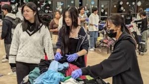 Members of the Clackamas High School Key Club sort donations at their Winter Blitz event