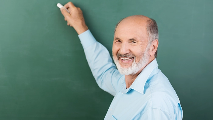 Smiling Kiwanis member at a playground building project